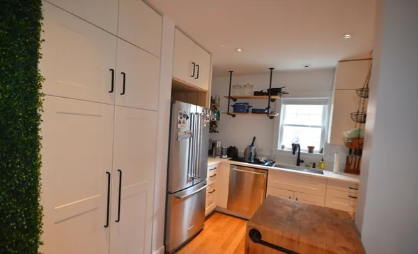 a kitchen with stainless steel appliances a refrigerator sink and microwave