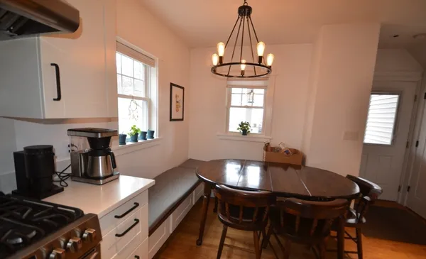 a view of a dining room with furniture and window