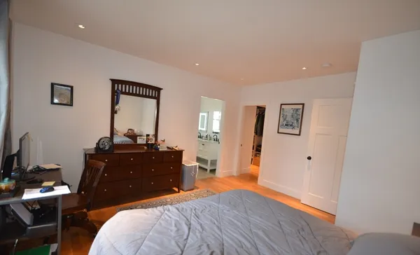 a bedroom with a bed and a mirror