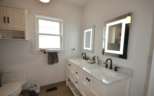 a bathroom with a granite countertop sink mirror and vanity