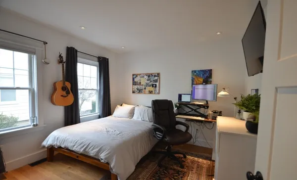 a bedroom with a bed and a window