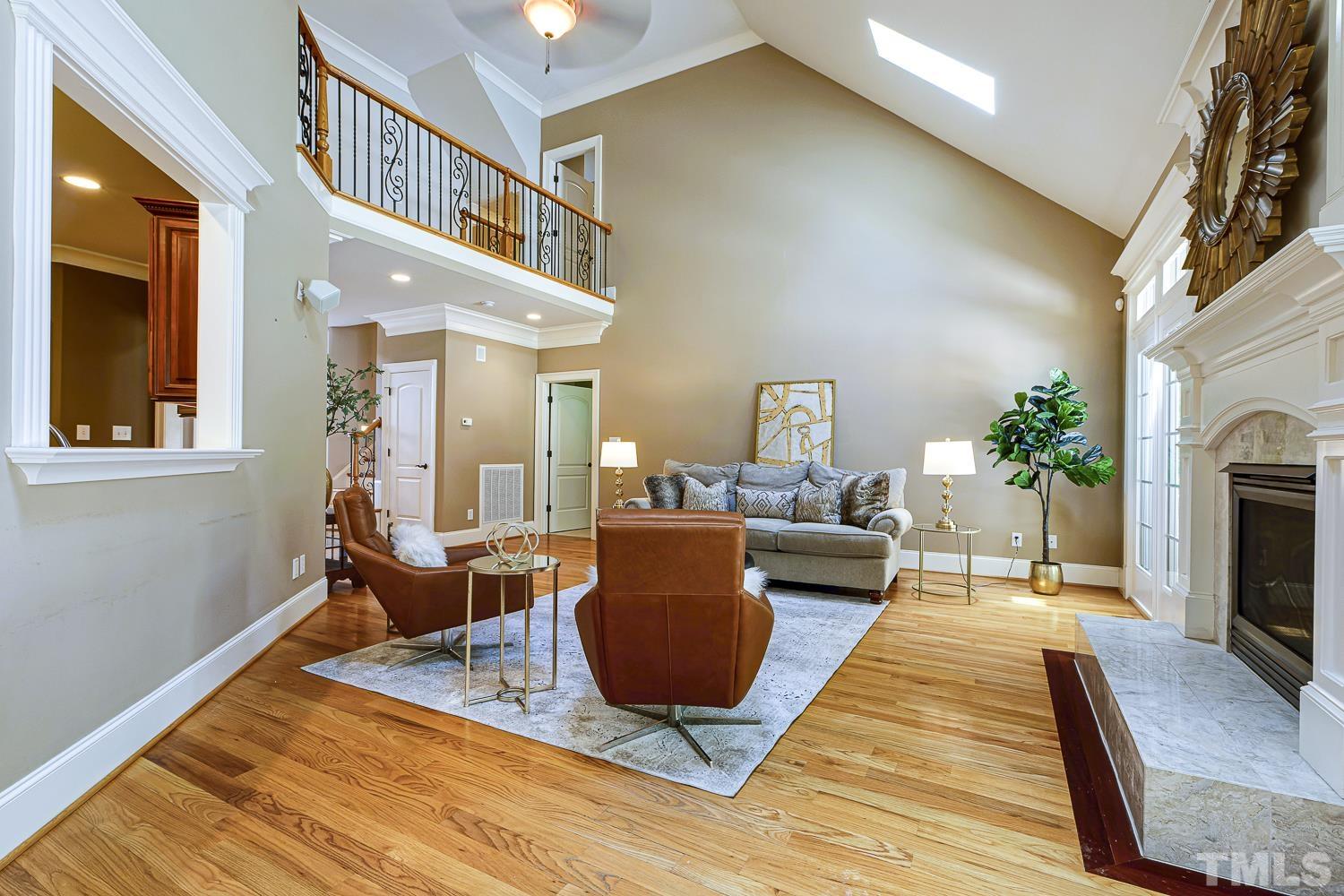 5201 Rathkeale Court Holly Springs, NC 27540 - Photo 14 of 46 a living room with furniture and a fireplace