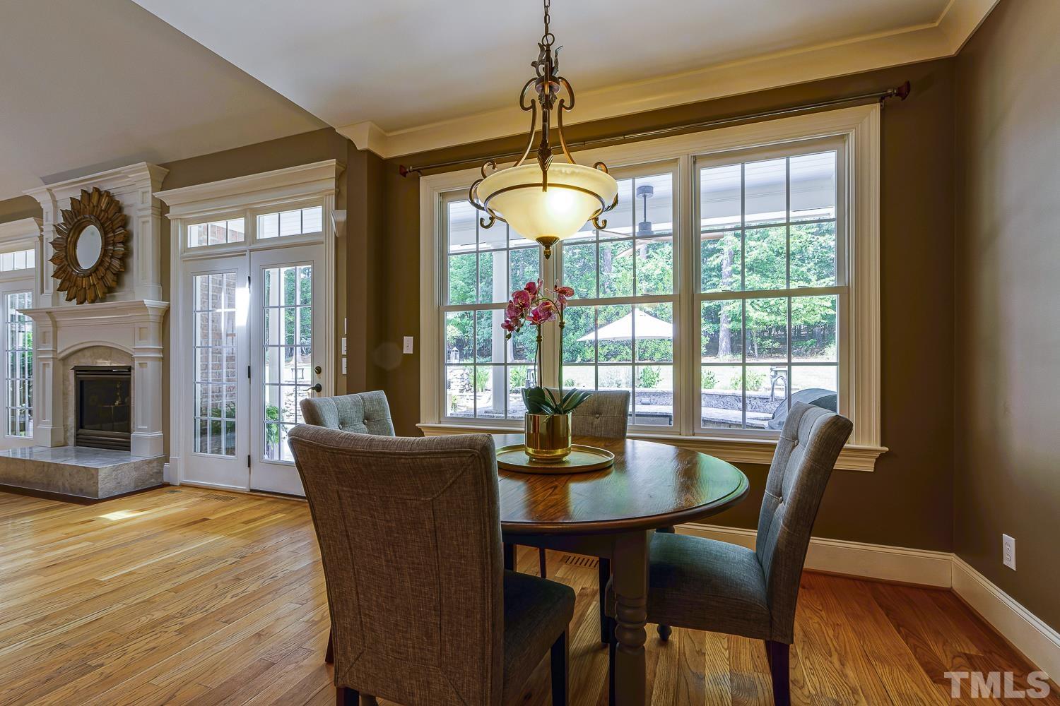 5201 Rathkeale Court Holly Springs, NC 27540 - Photo 15 of 46 a view of a dining room with furniture window and wooden floor