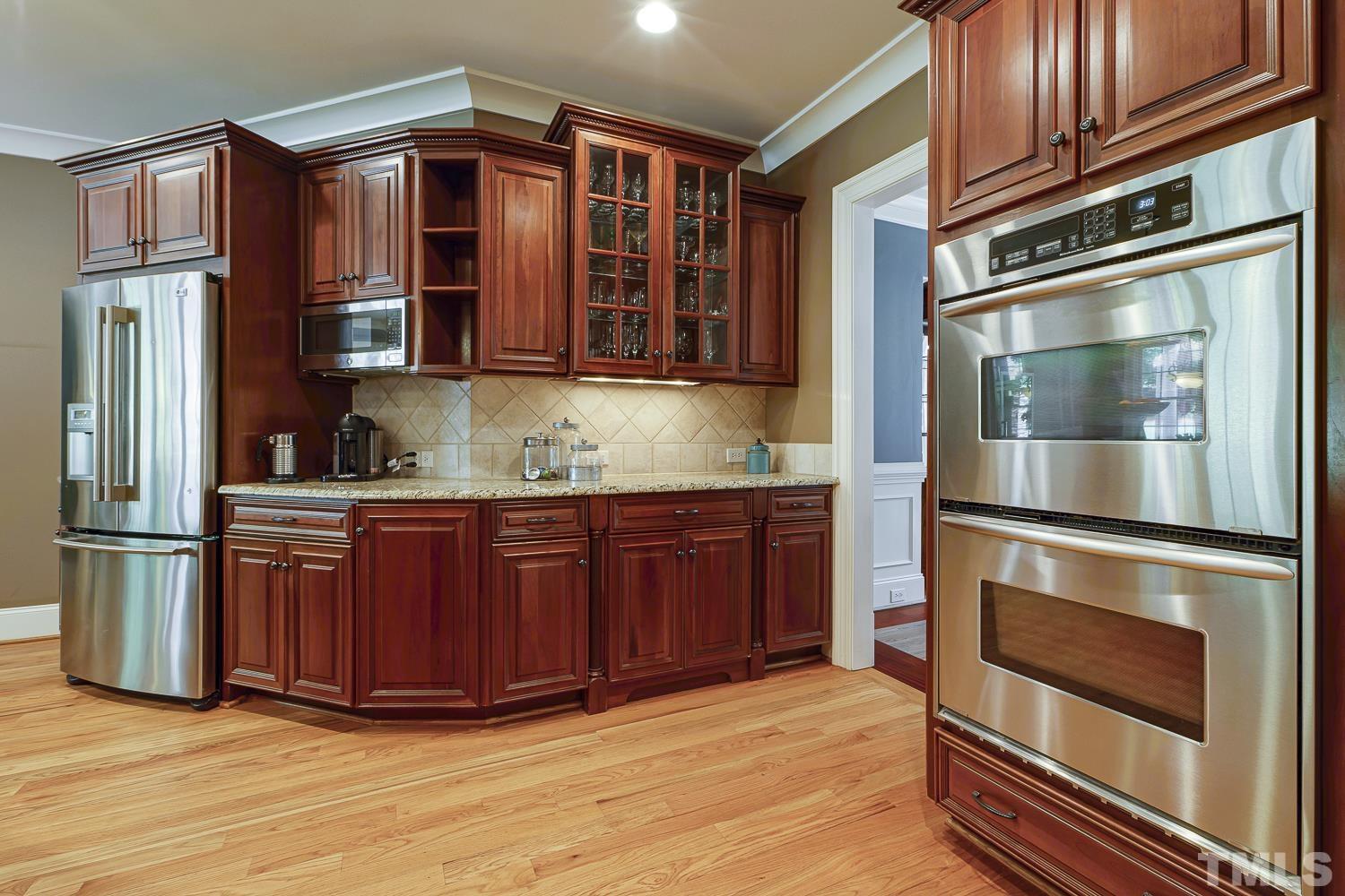 5201 Rathkeale Court Holly Springs, NC 27540 - Photo 18 of 46 a kitchen with stainless steel appliances granite countertop a refrigerator and stove