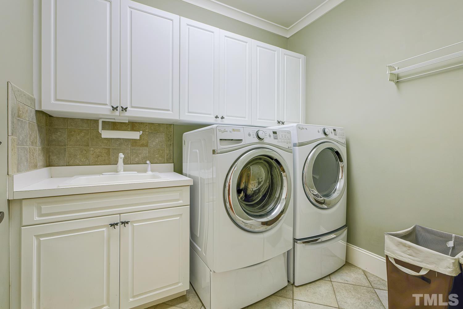 5201 Rathkeale Court Holly Springs, NC 27540 - Photo 24 of 46 a utility room with dryer and washer
