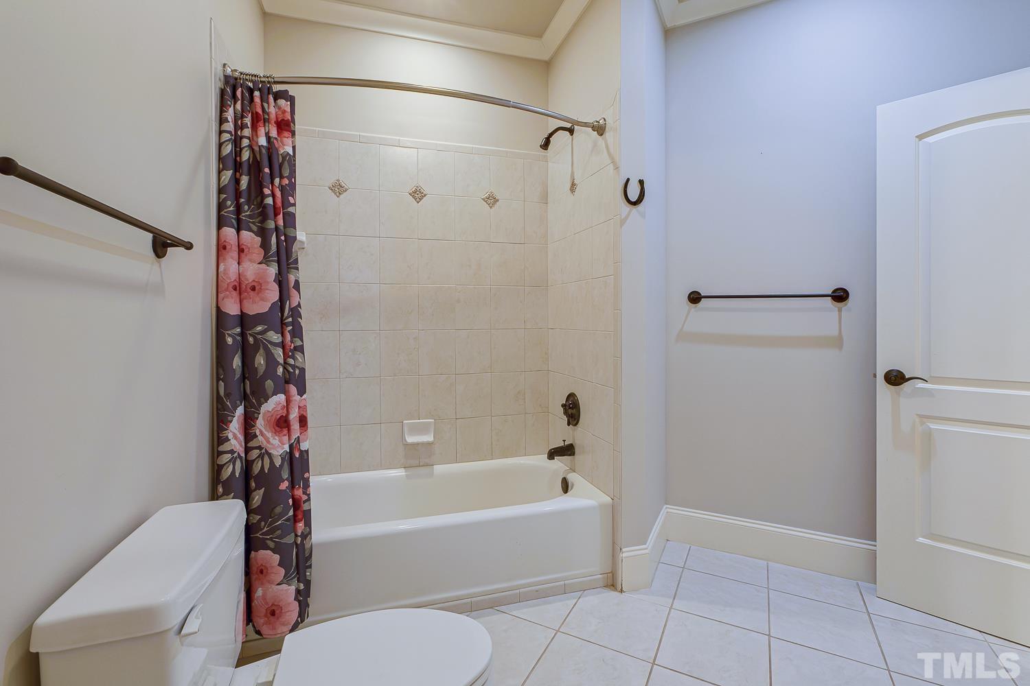 5201 Rathkeale Court Holly Springs, NC 27540 - Photo 27 of 46 a bathroom with a bathtub and shower