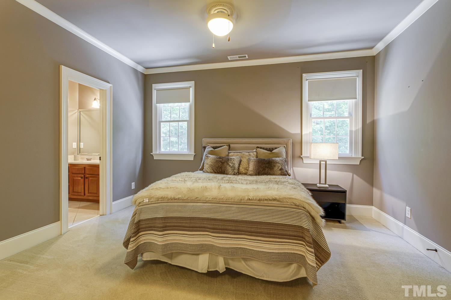 5201 Rathkeale Court Holly Springs, NC 27540 - Photo 30 of 46 a bedroom with a bed and wooden floor