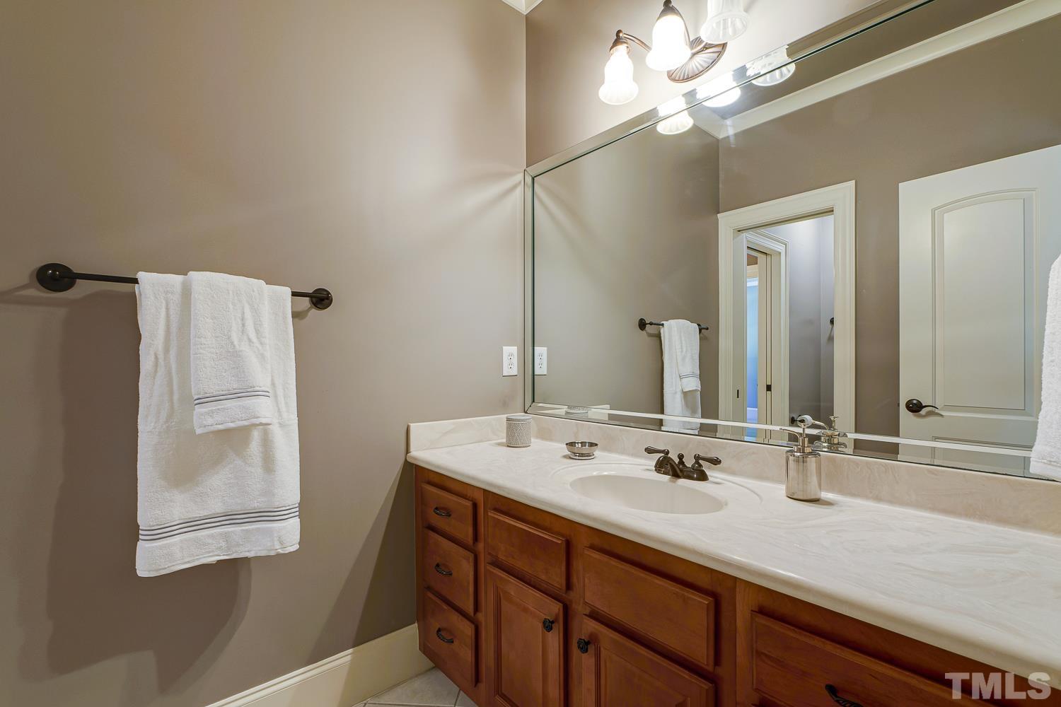 5201 Rathkeale Court Holly Springs, NC 27540 - Photo 31 of 46 a bathroom with a sink and a mirror