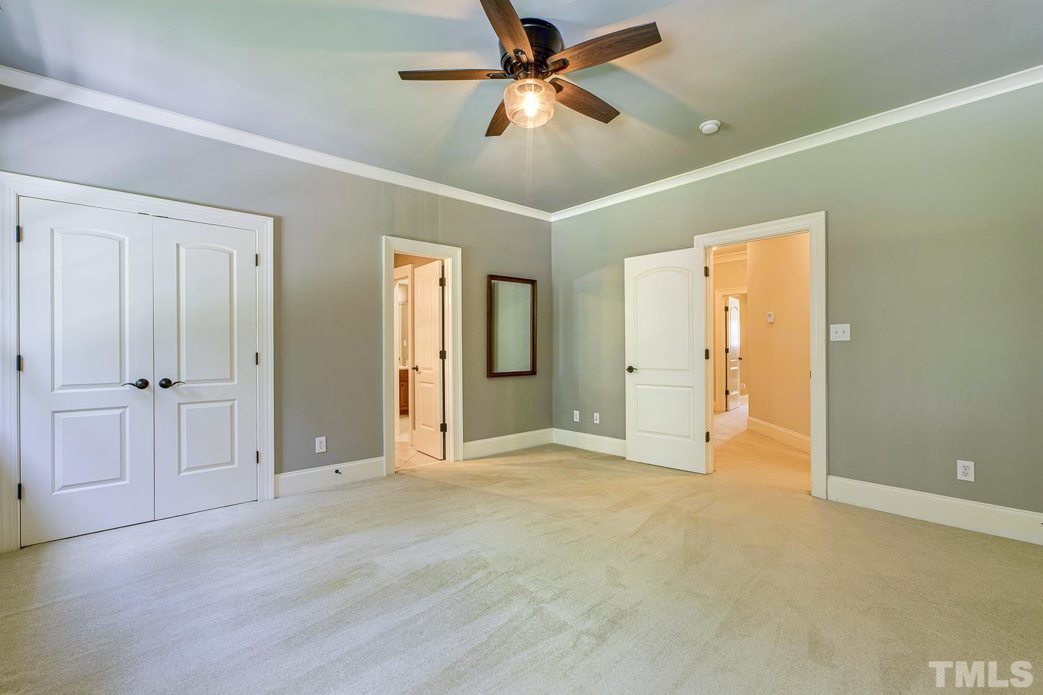 5201 Rathkeale Court Holly Springs, NC 27540 - Photo 33 of 46 an empty room with closet and a ceiling fan