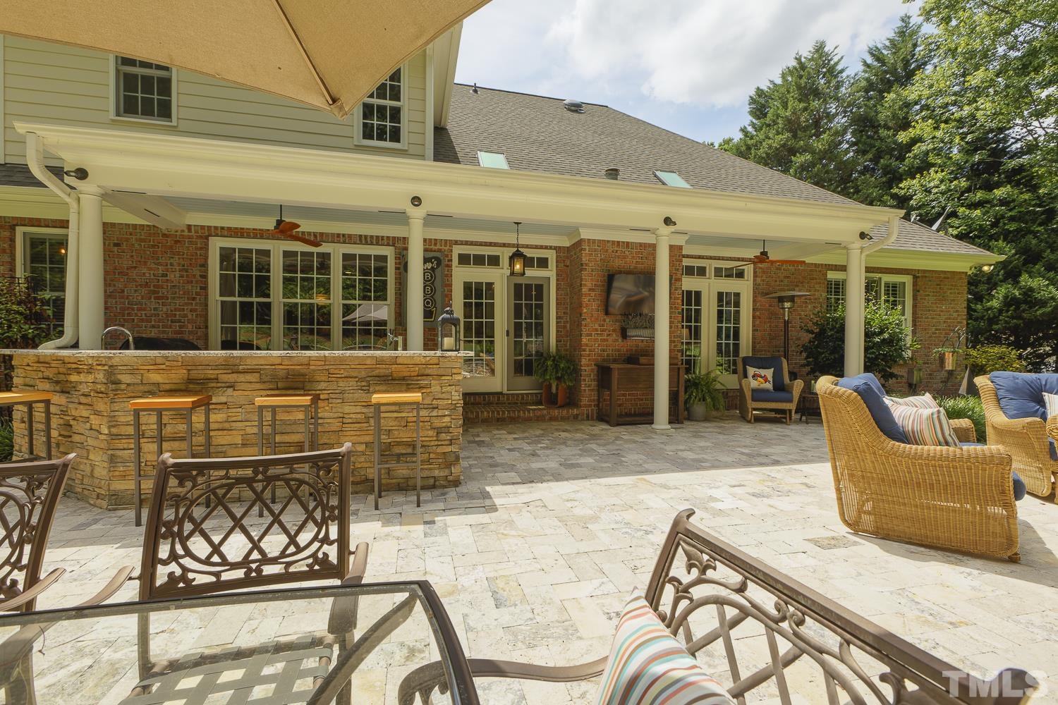 5201 Rathkeale Court Holly Springs, NC 27540 - Photo 37 of 46 front view of a house with a chairs and table in a patio