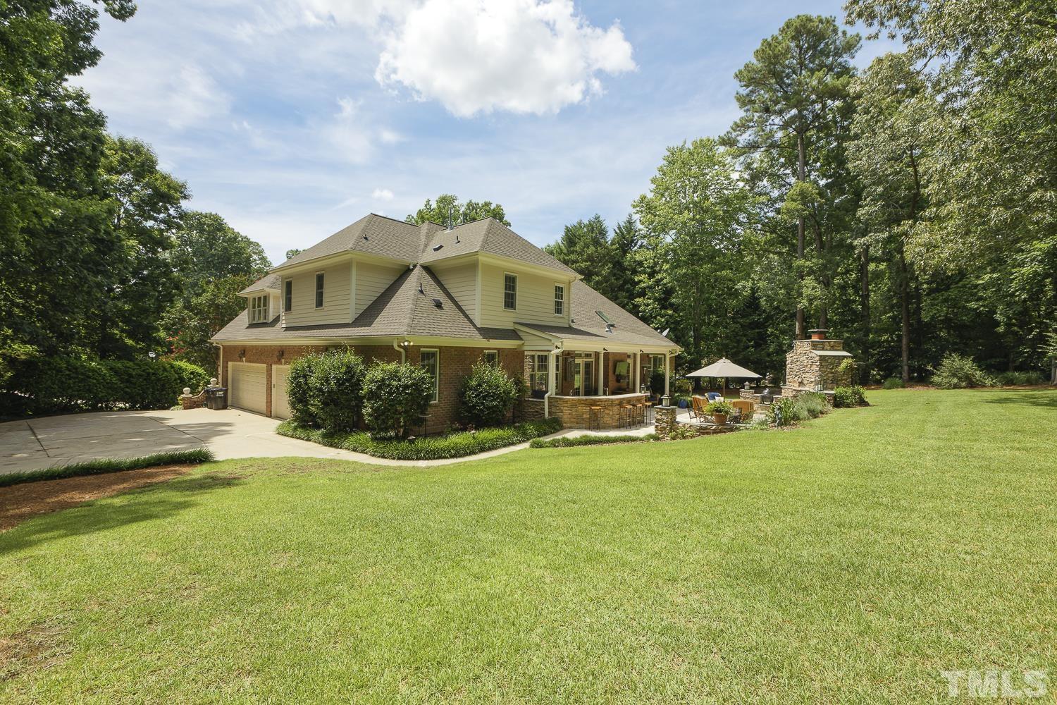 5201 Rathkeale Court Holly Springs, NC 27540 - Photo 39 of 46 a view of a house with a big yard and large trees