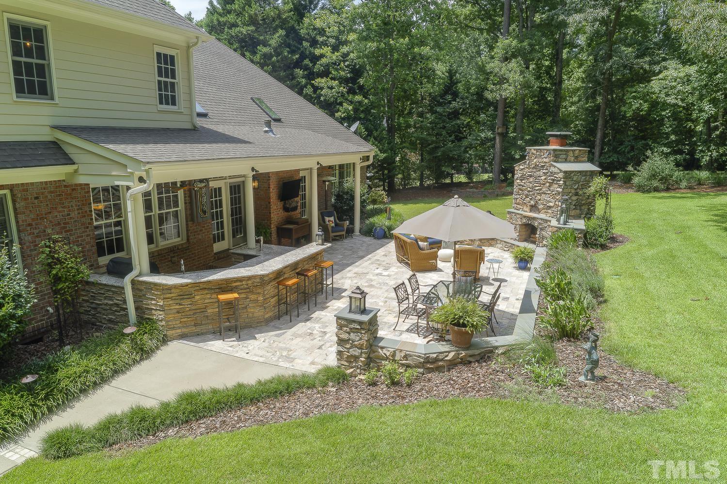 5201 Rathkeale Court Holly Springs, NC 27540 - Photo 45 of 46 a view of a house with backyard sitting area and garden