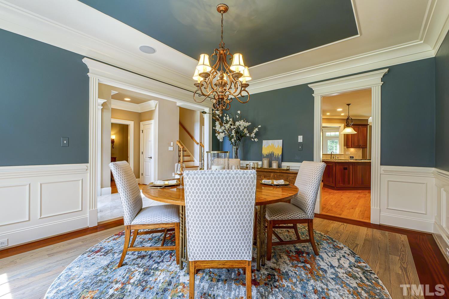 5201 Rathkeale Court Holly Springs, NC 27540 - Photo 7 of 46 a dining room with wooden floor and a chandelier