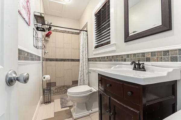 a bathroom with a sink toilet and shower