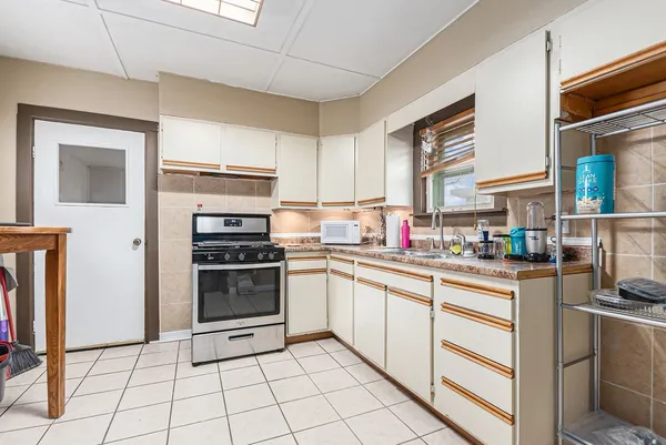 a kitchen with a stove a sink and a refrigerator