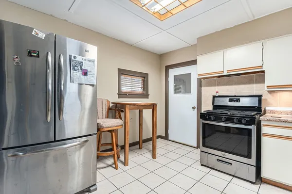 a kitchen with stainless steel appliances granite countertop a refrigerator sink and stove