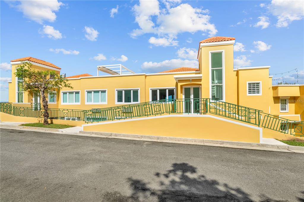 10 F, Unit 201 Rio Grande, PR 00745 - Photo 1 of 1 a view of an house with swimming pool and large tree