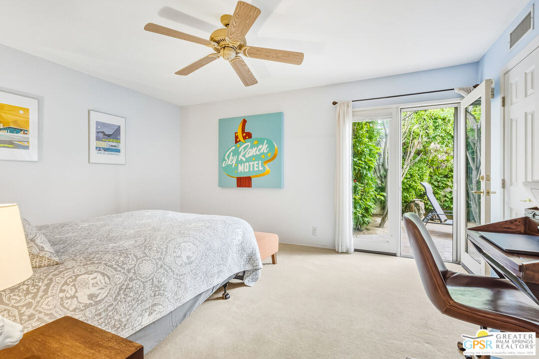 1103 East Alejo Road Palm Springs, CA 92262 - Photo 21 of 39 a bedroom with a bed a couch and a window