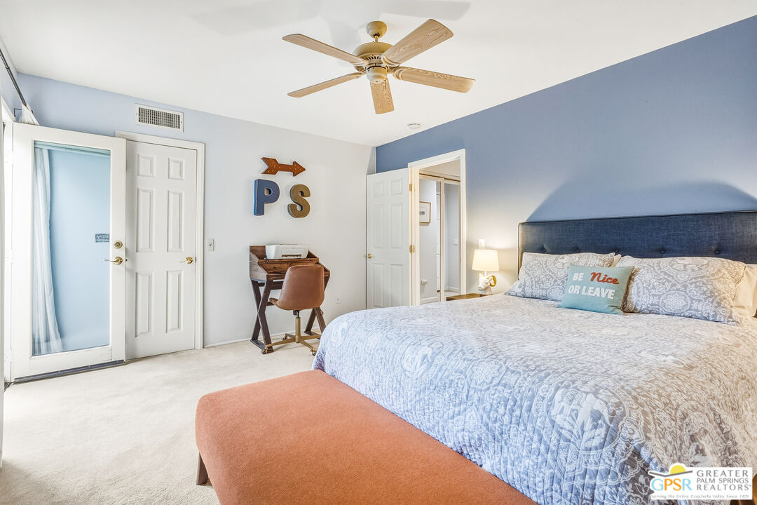 1103 East Alejo Road Palm Springs, CA 92262 - Photo 22 of 39 a bedroom with a bed and a chandelier