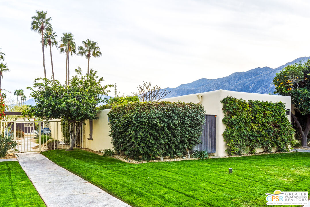 1103 East Alejo Road Palm Springs, CA 92262 - Photo 3 of 39 a view of a house with a yard and potted plants