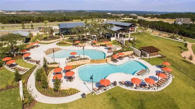 an aerial view of a swimming pool with a mountain view
