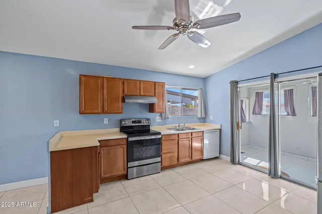 a kitchen with stainless steel appliances granite countertop a stove sink and refrigerator