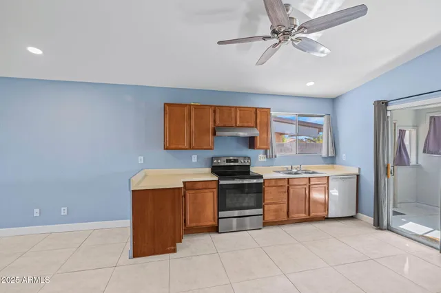 a kitchen with a stove top oven and cabinets