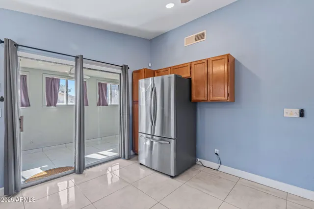 a kitchen with stainless steel appliances granite countertop a refrigerator and cabinets
