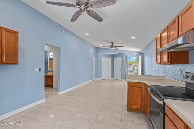 a view of a kitchen with a sink and dishwasher with wooden floor