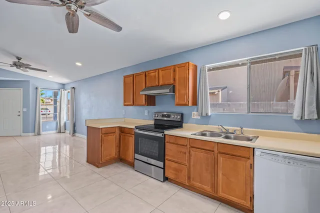 a kitchen with stainless steel appliances granite countertop a stove sink and cabinets