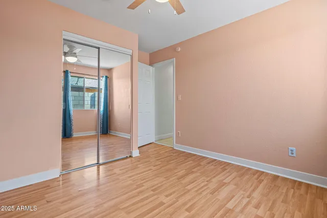 an empty room with wooden floor and door