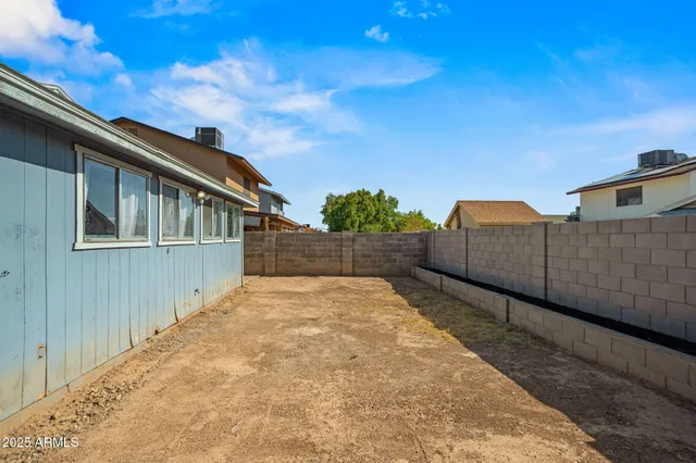 a view of a house with wooden fence