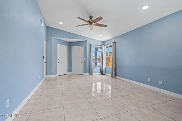 a view of a livingroom with a ceiling fan and window