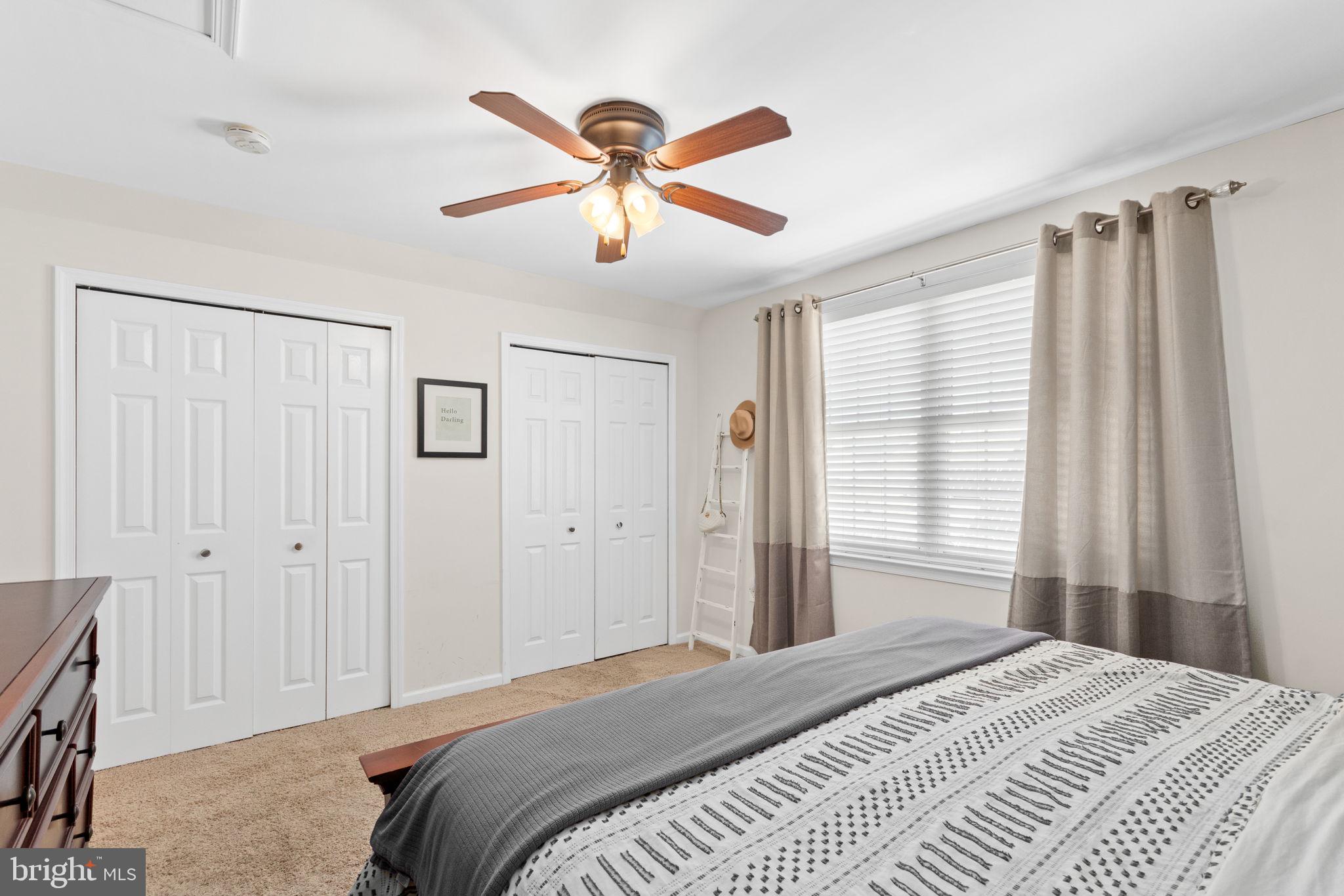 93 Weathervane Drive Mount Royal, NJ 08061 - Photo 12 of 22 a bedroom with a large bed and a chandelier