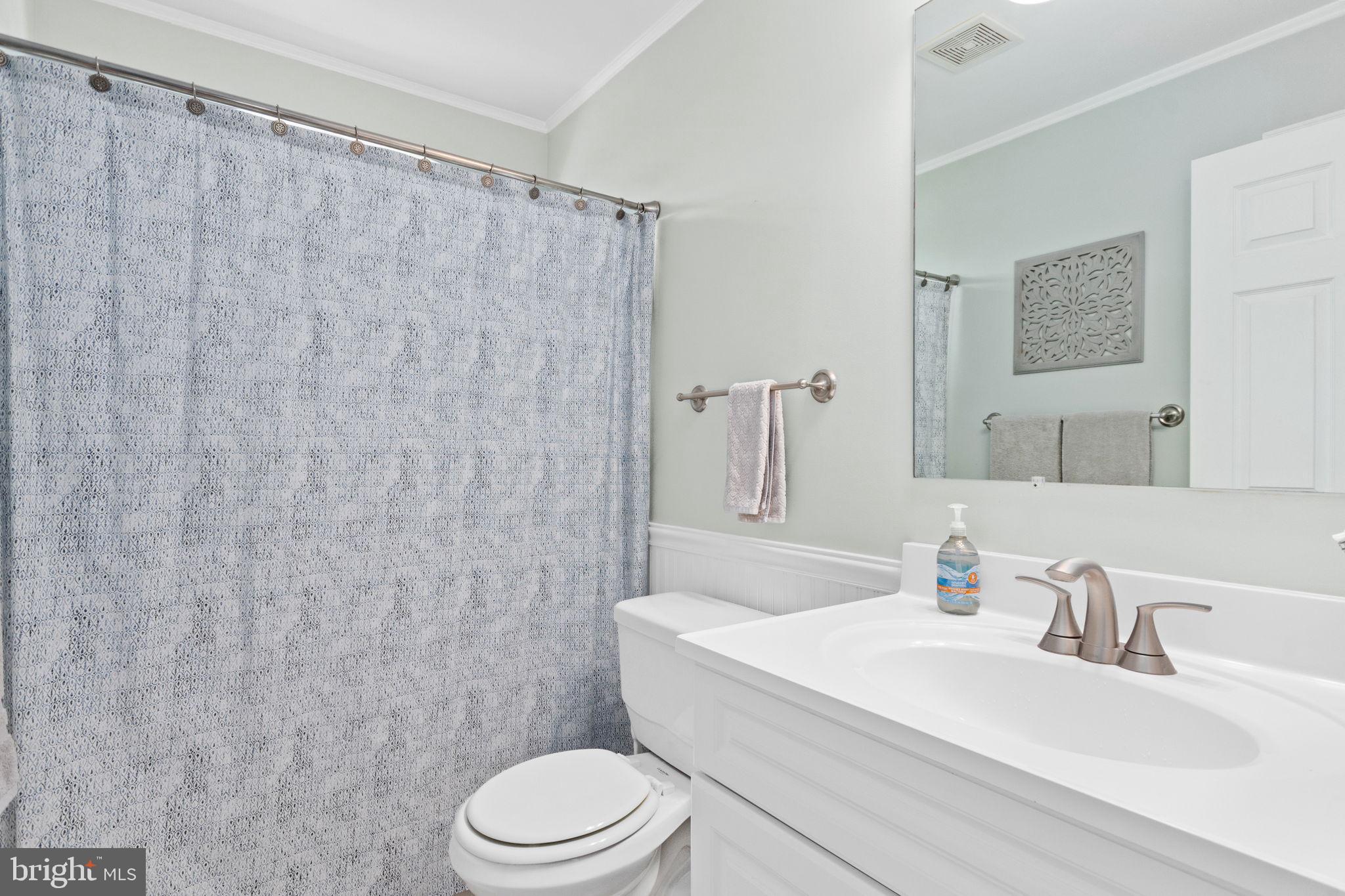 93 Weathervane Drive Mount Royal, NJ 08061 - Photo 15 of 22 a bathroom with a white toilet sitting next to a white sink and a shower curtain