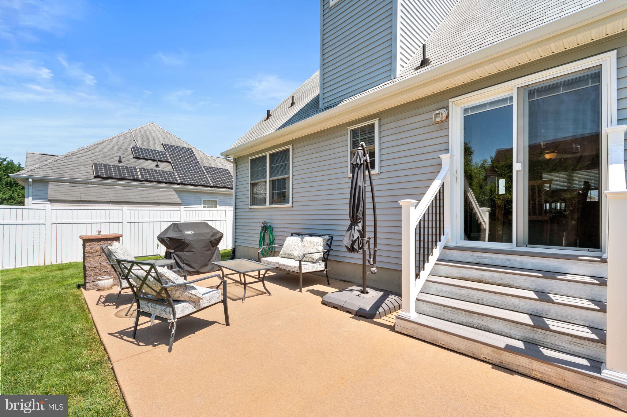 93 Weathervane Drive Mount Royal, NJ 08061 - Photo 21 of 22 a view of a patio with table and chairs and couches with wooden floor and fence