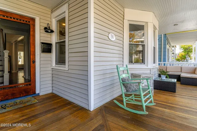 a view of a porch with furniture and wooden floor