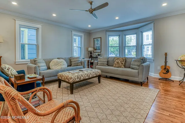 a living room with furniture ceiling fan and a rug