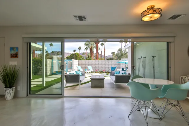 a dining room with furniture and wooden floor