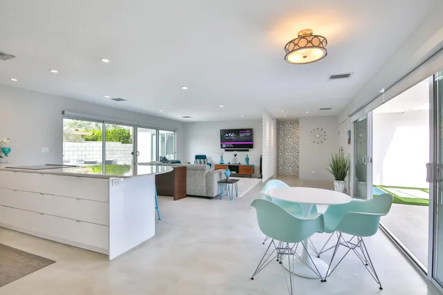 a bedroom with a bed and large windows