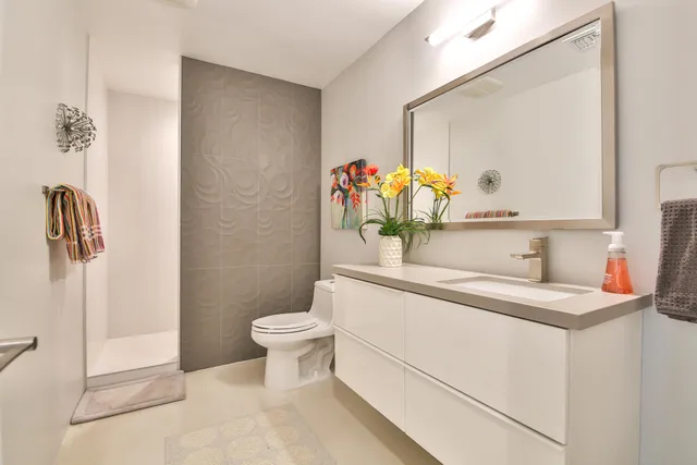 a close view of a sink a counter space and a refrigerator in a kitchen