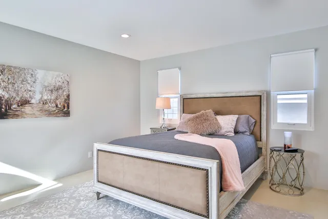 a bedroom with a large bed and a window