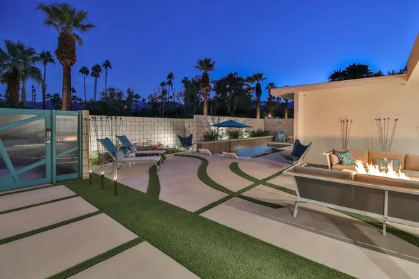 a view of a house with a yard and sitting area