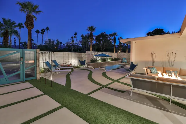 a view of a house with a yard and sitting area