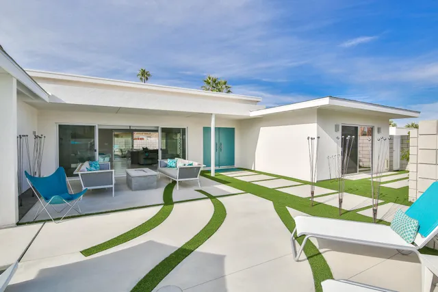 a bedroom with furniture and a flat screen tv