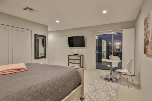 a living room with furniture a table and chairs