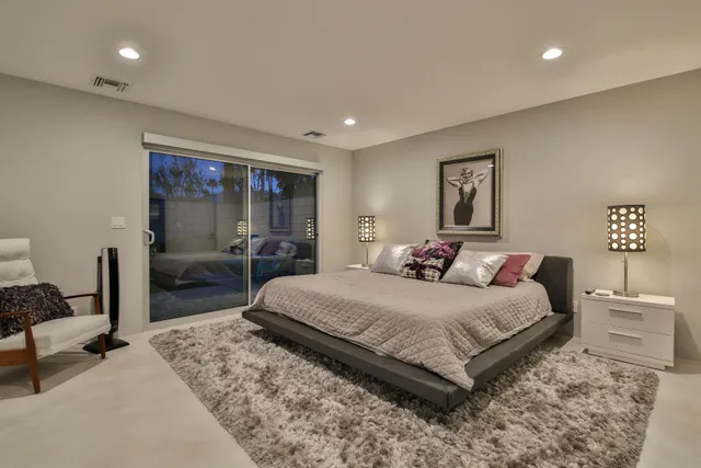 a living room with furniture a pool table and a large window