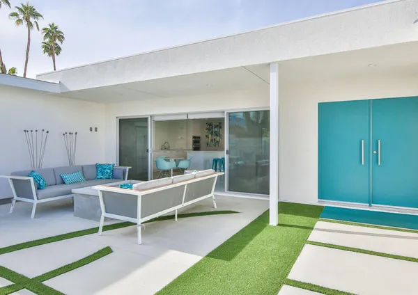 a view of a patio with a dining table and chairs