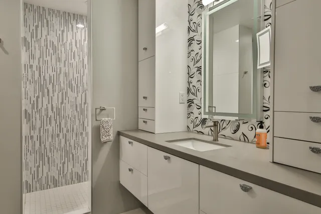 a living room with furniture a rug and a potted plant