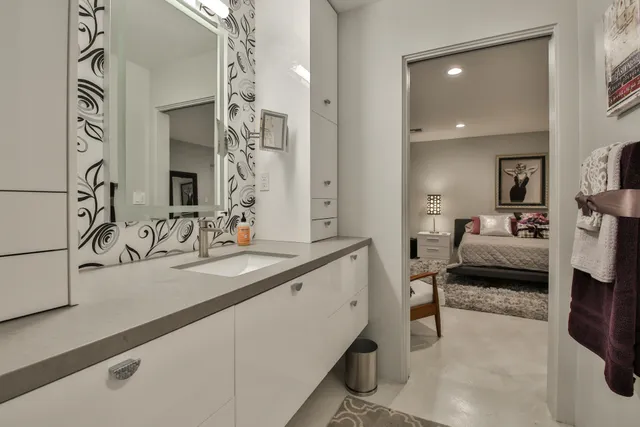 a bedroom with a bed and a lamp